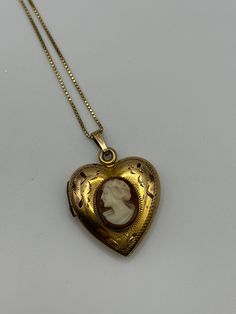 This is a beautiful vintage heart shaped cameo locket on a chain. The cameo looks to be hand carved and the locket is marked as 12k gold filled. The chain is 10k signed Italy and is 17 inches long and 1/16 inches wide. They are both in excellent antique condition. The locket opens, closes, and locks smoothly. Vintage 14k Gold Locket Necklace, Vintage 14k Gold Locket Necklace Stamped 14k, Victorian Brass Necklace With Heart Charm, Victorian 14k Gold Heart-shaped Jewelry, Antique Heart-shaped 14k Gold Necklace, Victorian 14k Gold Heart Shaped Jewelry, Victorian Medallion Jewelry With Heart Charm, Victorian 14k Gold Heart Jewelry, Antique Heart Locket Necklace For Formal Occasions