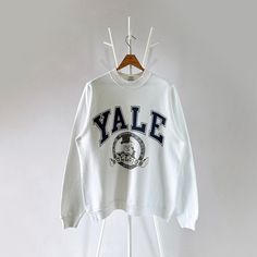 90s Yale University Bulldogs crewneck sweatshirt/ L * PLEASE READ BEFORE PURCHASE * PLEASE consider the PHOTOS before making the decision * The images may DIFFER in appearance from the actual product because we took pictures under daylight.  * PLEASE send your PHONE NUMBER after your purchase for the shipping company to contact you X No returns X No refund Condition : 9/10 More details : look at the pictures  Brand : Screen star Size On Tag : L Pit to pit/ Chests : 23.5/47 inches  Length : 27.5 inches  Material : cotton polyester  Color : white  * Payment accept PayPal only * ALL ITEMS are VINTAGE which may show some signs of wear and tear * Due to the different display and different light, the picture may not reflect the actual color of the item Thank you RG/10/7/23 90s Style Crew Neck Sweatshirt With Screen Print, 90s Crew Neck Sweatshirt With Screen Print, Vintage Graphic Print Sweatshirt For Campus, College Style Crew Sweater For Streetwear, Vintage Crew Neck Sweatshirt For Streetwear, Yale Bulldogs, Yale University, Shipping Company, Phone Number