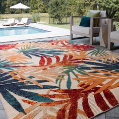 an outdoor area rug in front of a swimming pool