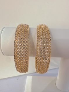 Gold Finish American Diamond/CZ Bangles/Bracelet/Indian Party Wear Bangles/ CZ stone bangles/Indian wedding/bridal jewelry Sold as a pair Opening :NOT Screw type Plating:-  gold plated CZ stone bangle Best gift option for your loved ones comes in an exquisite gift box. Gold Plated Diamond Accented Bracelets For Weddings, Gold Plated Wedding Bracelets With Diamond Accents, Gold Crystal Bangle As Gift, Wedding Gold Plated Bracelets With Diamond Accents, Wedding Bracelets With Diamond Accents, Gold Plated, Wedding Bracelets With Diamond Accents And Gold Plating, Gold Diamond Bracelet With Rhinestones, Sparkling Hoop Jewelry For Wedding, Gold Plated Rhinestone Jewelry For Wedding