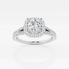 a cushion cut diamond ring with pave set diamonds on the shoulders and sides, in white gold