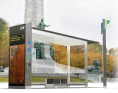 a bus stop with a statue in the background