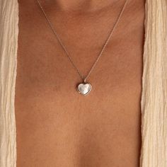 Our Mother of Pearl Heart Locket combines both sentimentality and elegance. Insert any picture that is close to your heart in the dainty locket charm and allow that image to bring you peace whenever you need it. The delicate chain and pendant are perfect for layering with your other meaningful pieces to create a nostalgic jewelry look. SKU: RR-NR171 Product Details Material: High Quality Solid 925 Sterling Silver Finish: Sterling Silver ∙ 18K Gold Locket comes without a photo. Photo insertion se Couples Lockets Necklaces, Delicate Heart Charm Necklace With Round Pendant, Dainty Heart Locket Necklace, Everyday Heart Locket Necklace For Valentine's, Dainty Heart Pendant Locket Necklace With Charm, Dainty Heart Locket Necklace With Charm, Heart Shaped Dainty Locket Necklace With Delicate Chain, Dainty Heart Locket Necklace With Delicate Chain, Dainty Medallion Charm Necklace As Keepsake