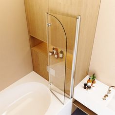 a bath tub sitting next to a white sink under a bathroom mirror on top of a wooden cabinet