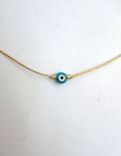 Evil eye choker necklace, String choker, Minimalist The evil eye is used to protect the person that wears it from the malevolent look of others who envy or dislike that person. The necklace is made with 1mm silver/gold waxed string,and has a 8mm emerald glass evil eye bead. At the end it is adorned with seed beads. Total length: 80cm / 31 inches It is adjustable to fit a lot of sizes. Custom orders for different colour combinations are welcome. Other necklaces in my shop: https://www.etsy.com/sh Adjustable Delicate Chain Choker As Gift, Evil Eye Choker Necklace As Gift, Evil Eye Choker Necklace For Gift, Adjustable Dainty Evil Eye Jewelry, Handmade Adjustable Eye-shaped Jewelry, Minimalist Handmade Choker As A Gift, Minimalist Handmade Choker As Gift, Adjustable Evil Eye Choker Necklace, Adjustable Evil Eye Choker Jewelry