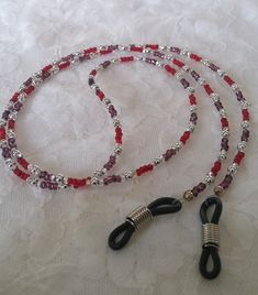 This Eye glass chain is made up of:  *Purple silver lined seed beads  *Red silver lined seed beads *Silver spacers *It's 27-1/2 inches in length approx. *-Eye glass holders are in silver finish with black rubber tip. A cute gift bag and tissue is included. All Waterfall Creations 4U are handmade by me, Janice.  :) I so enjoy creating, and I try to keep the price as low as I can depending on how many and what stones and material I use. I must charge for shipping as mailing is to costly to absorb. Silver Glass Beaded Necklaces With Spacer Beads, Adjustable Glass Necklace With Silver Beads, Silver Glass Beaded Necklace With Spacer Beads, Silver Glass Beads For Gift, Silver Glass Beaded Necklace With Colorful Beads, Handmade Silver Glass Beads, Silver Beaded Necklace With Colorful Glass Beads, Silver Glass Jewelry With Colorful Beads, Silver Glass Beaded Necklaces For Party