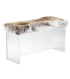 a clear bench with a fur covered seat cover on the top and bottom part, against a white background