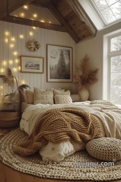 a bed with blankets and pillows on top of it in a room filled with lights