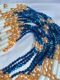 Double Strand Waist Bead "Koffikro" features two strands adorned with rich, deep blue glass seed beads. Dive into the enchanting allure of this accessory, designed to add a touch of sophistication and mystery to your style. 🌌 Blue : Immerse yourself in the deep and luxurious shades of blue that adorn each strand of this waist bead. The profound color symbolizes tranquility and depth, making it a perfect choice for expressing your inner calm and timeless elegance. 🌟 Double Strand: The double strand design adds a layer of opulence and texture, creating a visually stunning and intricate accessory. The strands cascade gracefully, allowing you to make a bold and refined statement with every movement. 🔵 Versatile Expression: Whether worn under clothing for a discreet touch or as a visible sta Elegant Blue Faceted Beads, Blue Beaded Chain Bracelets For Party, Handmade Blue Double Strand Beaded Bracelets, Multi-strand Blue Spacer Beads, Blue Multi-strand Spacer Beads, Blue Faceted Beaded Necklaces For Party, Adjustable Sapphire Beaded Necklaces With Round Beads, Blue Czech Glass Beaded Chain, Blue Polished Beaded Necklaces For Parties