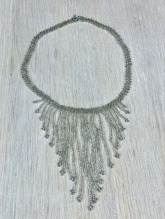 "This light grey beaded fringe necklace would look great with a cocktail dress of almost any colour.  Necklace length 37 cm (14.6\"), longest fringe 10 cm (4\") Very good vintage condition.  Check out the other jewelry I have for sale: https://www.etsy.com/shop/IamMiaFinland?section_id=28315483 SHIPPING - I ship worldwide via DHL global mail.  - Please allow 1 to 4 weeks for the package to arrive if you live overseas. - Europe 2 - 10 business days. - DHL Express delivery service available for pu Silver Tassel Necklace For Party, Elegant Bib Necklace With Beaded Chain, Elegant Tassel Necklace For Party, Elegant Beaded Fringe Jewelry, Elegant Long Tassel Necklace With Fringe, Elegant Beaded Bib Necklace For Evening, Elegant Embellished Beaded Necklaces For Party, Elegant Embellished Beaded Necklace For Party, Elegant Silver Beaded Tassel Necklace