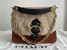 COACH Beat Brown/Brass Shoulder Bag In Suede Leather and Shearling NWT. New with tags, original dust bag included. For additional details please let me know. Thank you for looking. Luxury Winter Shoulder Bag, Designer Leather Bags For Winter, Luxury Leather Shoulder Bag With Faux Fur Lining, Designer Evening Bags For Winter, Let Me Know, Suede Leather, Dust Bag, Let Me, Thank You