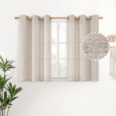 a window with curtains and a potted plant next to it on a table in front of a white wall