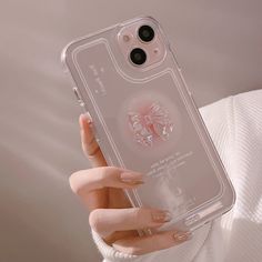 a woman is holding up her phone case with an image of a butterfly on it