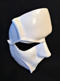 DESCRIPTIONHaunt the Paris Opera House Palais Garnier! You'll steal the stage in this extremely detailed white leather half-face mask is fabulous for theatre productions, masquerade balls, Mime costume or Halloween parties. Waterproofed, so fantastic for outdoor theater, Renaissance Festivals, or Burning Man. Any color. Waterproofed leather, glossy or matte finish, & several choices to affix the mask (cord, elastic, ribbon, waterproof cord, or no holes for adhesive). Measurements: 8" high x Phantom Of The Opera Mask Art, White Venetian Masks And Prosthetics For Theater, White Venetian Masks For Theater, Artistic White Mask For Theater, Luxury Artistic White Masks, Mime Costume, Opera Mask, Paris Opera House, Half Face Mask