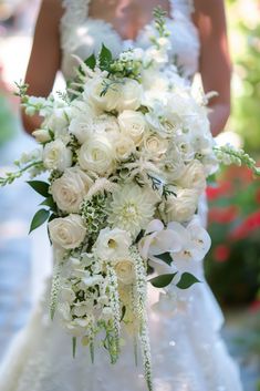 a bridal holding a bouquet of white flowers