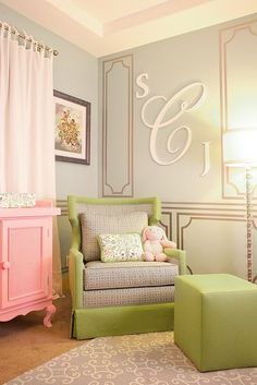 a baby's nursery room with pink, green and gray furniture in the corner