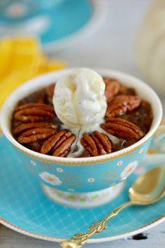 a bowl filled with pudding and pecans on top of a blue plate