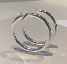 "Wide Oversized Hoop Earrings - 925 Italian Sterling Silver - 1 1/2\", 1 3/4\", 2\" and 2 3\\8\" diameter - extra wide tube, 6mm width tube 🎁Packaging: These Sterling Silver hoop earrings come gently packaged in a fabric pouch housed inside of a silver foil linen box with a silver bow. They are ready to present as a gift to someone special or to keep as a gift to yourself! 🚛 Shipping: Shipped from USA. Shipping is free within USA with tracking on all order $35 or more. Express delivery is avai Big Silver Hoop Earrings, Thick Silver Hoop Earrings, Oversized Hoop Earrings, Thick Hoop Earrings, Tube Packaging, Hoop Earrings Silver, Fabric Pouch, Silver Bow, Sterling Silver Hoop Earrings