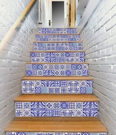 blue and white tiled stairs leading up to an open door