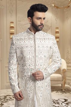 Crafted with intricate pearls and thread embroidery, the Mens Sherwani- U2-S350 is an exquisite choice for grooms. Its elegant design exudes sophistication, making it perfect for weddings. Elevate your wedding ensemble with this impeccable piece. Wedding Traditional Wear With Pearl Embroidery, Traditional White Bandhgala For Wedding, Eid Wedding Traditional Wear With Pearl Embroidery, Traditional Wear With Pearl Embroidery For Wedding Eid, Elegant Groom's Nehru Jacket With Dabka Work, White Traditional Wear With Resham Embroidery For Groom, White Embroidered Bandhgala For Wedding, Fitted Sherwani With Pearl Embroidery For Formal Occasions, White Embroidered Bandhgala For Reception