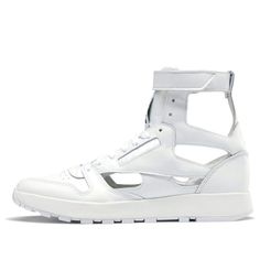 Looking for a hybrid sneaker that blends retro style with modern attitude? Check out the Reebok Maison Margiela x Classic Leather Tabi High in white. This unique sneaker is based on an early 80s runner, with a few twist courtesy of fashion house Maison Margiela. The result is a fresh take on a classic silhouette that's sure to turn heads. The Maison Margiela x Reebok Classic Leather Tabi High features Margiela's signature décortiqué technique, resulting in an open white leather build that's insp Reebok Classic Leather, Unique Sneakers, Sneakers Looks, Marathon Running Shoes, Reebok Classic, Running Shoes Sneakers, Fashion House, Classic Leather, Wedge Sneaker