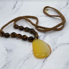 Brand New French Connection Necklace. Semiprecious Gorgeousness! A Total Of 12 Tiger Eye Beads With A Yellow Agate Pendant. Total Length Of The Tan, Braided Suede Necklace Is 36”. The Agate Pendant Is 2 1/4” In Length And Width Is 1.5”. No Clasp. Natural Beauty. Ships Quickly And From A Smoke Free Environment. Yellow Spiritual Beaded Necklace With Gemstone Beads, Yellow Agate Jewelry With Natural Stones, Yellow Gemstone Beaded Necklaces For Gifts, Yellow Beaded Necklaces With Natural Stones As Gift, Yellow Beaded Necklaces With Natural Stones For Gifts, Yellow Gemstone Beaded Necklaces As Gift, Yellow Gemstone Beaded Necklace For Gifts, Adjustable Yellow Beaded Necklace For Spiritual Use, Yellow Agate Gemstone Jewelry