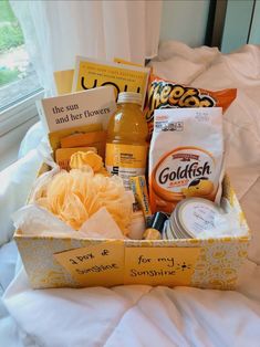 a basket filled with lots of different items on top of a bed