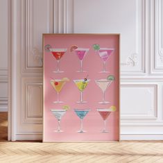 a pink poster with different types of cocktails on it in front of a white wall