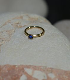 2mm Blue Sapphire TRAGUS EARRING // Gold Nose Ring - Tragus Piercing - Conch Piercing - Cartilage Ho 14k Gold Huggie Jewelry With Bezel Setting, 14k Gold Small Hoop Gemstone Jewelry, 14k Gold Gemstone Hoop Jewelry, Everyday Gold Sapphire Jewelry, Yellow Gold Stackable Cartilage Earrings As Gift, Stackable Yellow Gold Cartilage Earrings As Gift, 14k Gold Hoop Earrings With Bezel Setting, 14k Gold Birthstone Hoop Jewelry, Stackable Huggie Rings Perfect For Gifts