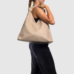 The Como Shoulder Bag by Urban Originals is a stylish double knot hobo crafted from woven vegan leather. Designed to be roomy, it effortlessly accommodates your everyday essentials with flair. Woven Leather Hobo Tote Bag For On-the-go, Modern Woven Leather Shoulder Bag For Errands, Everyday Woven Leather Hobo Bag, Modern Woven Hobo Bag With Double Handle, Modern Woven Double Handle Hobo Bag, Everyday Leather Shoulder Bag With Interwoven Design, Modern Woven Leather Hobo Bag For Daily Use, Leather Hobo Bag With Interwoven Design For Everyday, Intrecciato Weave Hobo Shoulder Bag For On-the-go