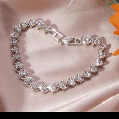 Heart Silver Plated Rhinestone Tennis Bracelet Heart Shaped Bracelet New This Is A Beautiful Elegant Heart Shaped Rhinestone Bracelet That Is Silver Plated! I Ship Items Out Every Day! Expect To Receive This Bracelet As Soon As Possible! Crystal Heart Bracelet Gift, Silver Rhinestone Bracelets For Valentine's Day, Silver Crystal Heart Bracelet For Wedding, Elegant Metal Heart Bracelet For Party, Valentine's Day Silver Bracelets With Rhinestones, Valentine's Day Silver Bracelet With Rhinestones, Crystal Heart Bracelet For Wedding And Valentine's Day, Heart-shaped Rhinestone Bracelet As Gift, Elegant Rhinestone Bracelets For Valentine's Day