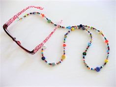 "Colorful and fun Beaded Eyeglass Chain, and Necklace combination handmade by Ralston Originals. This is a unique original style Eyeglass Chain and Necklace combination designed by Ralston Originals. Unique from any other Eyeglass Chains on Etsy, Ralston Originals was the first to add the lobster clasp at the end of the chain to join together to make a Necklace. Brilliant! This makes it even more unique because you now have two pieces of jewelry in one!!. Wear it to work or out shopping as a Nec Colorful Adjustable Glass Beaded Necklaces, Fun Handmade Adjustable Beads, Multicolor Handmade Glass Beads, Handmade Round Glass Beads, Glass Glasses Chains With Colorful Beads For Gifts, Gift Glasses Chains With Colorful Glass Beads, Gift Colorful Glass Beads Glasses Chains, Handmade Colorful Glass Beaded Necklaces, Colorful Handmade Glass Beaded Necklaces