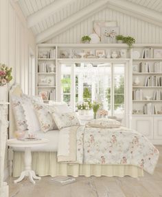 a bedroom with white furniture and flowers on the bedspread is shown in this image