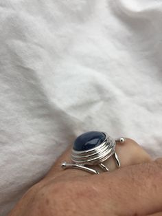 great color Deep blue Kyanite stone surrounded by a cool modern setting The setting is handcrafted in Sterling silver Size 7.5 Can be sized All rings are shipped in a nice gift box. Check out our over a THOUSAND great reviews Engraving is $4 per letter and is not always perfect depending on the piece. It can take a few days if the jeweler is busy. This is payable to Paypal Judithsltd@gmail.com Modern Cabochon Sapphire Ring For Gift, Modern Sterling Silver Moonstone Ring Gift, Sapphire Moonstone Ring In Sterling Silver As Gift, Silver Sapphire Ring With Round Stone For Gift, Modern Blue Rings With Large Stone, Unique Blue Cabochon Moonstone Ring, Unique Blue Moonstone Cabochon Ring, Unique Blue Moonstone Ring, Unique Sapphire Sterling Silver Ring