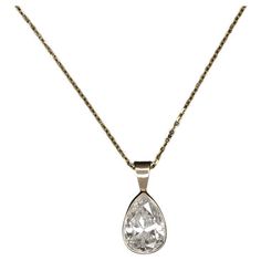 This diamond solitaire necklace exudes classic luxury, showcasing a substantial 1.80ct pear-shaped diamond nestled in a streamlined 14k yellow gold bezel setting for a sleek appearance. The necklace features an impressively sized natural diamond that boasts a great spread, offering the visual grandeur of a conventional 2 carat pear. The J color diamond displays very minimal warmth, presenting a strikingly white appearance against the lustrous yellow gold. Crafted for both beauty and quality, the Classic Brilliant Cut Drop Necklace For Formal Occasions, Luxury Pear-shaped Drop Necklace For Anniversary, Classic Formal Drop Necklace With Diamond Cut, Classic Pear-shaped Diamond Drop Necklace, Classic Diamond Teardrop Pendant Necklace, Classic Pear Shaped Diamond Drop Necklace, Formal Pear-shaped Solitaire Necklace, Classic Teardrop Pendant Drop Necklace With Brilliant Cut, Elegant Pear-shaped Solitaire Necklace For Formal Occasions