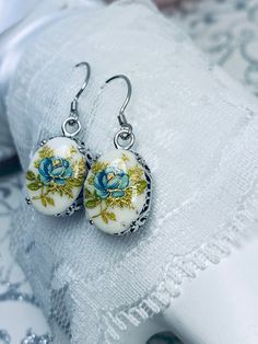 Painted Cameo Earrings Design#E70 Made to Order This is a brand new beautiful Art Nouveau/Art Deco-inspired filigree sterling silver pair of painted floral cameos. The lovely oval cameos are 14mm (5/8th of an inch) by 12mm (1/2 inch) in size each. The earrings are marked 925.  The earrings are 1 1/4th inches long. Notice the beautiful swirl/heart like the craftsmanship of the silver filigree settings. This is a well made beautiful pair of sterling earrings and they are ready to wear. A gift box Handmade Oval Vintage Earrings, Handmade White Oval Earrings, Vintage White Oval Earrings, Handmade White Flower Earrings For Formal Occasions, Handmade Bohemian Earrings For Formal Occasions, Formal White Handmade Flower Earrings, Jewelry Flowers, Cameo Earrings, Edwardian Jewelry