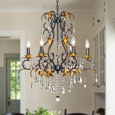 a chandelier hanging from the ceiling in a dining room