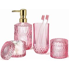 pink glass bathroom accessories including toothbrush holder, soap dispenser and tumbler