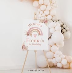 a welcome sign with balloons in the background