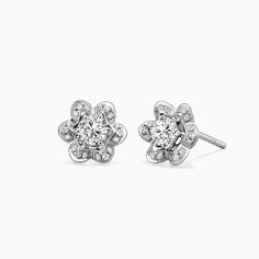 pair of white gold and diamond earrings with flower design on the front, set in 18k white gold