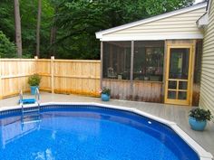 a small backyard with a pool and deck