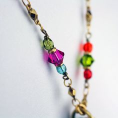 This heart hoop necklace embellished with a wide variety of multi-color Swarovski crystal and glass beads set into rainbow enamel placed on a chain beaded with Swarovski crystals and glass beads is inspired by it's own abstract and bright shape. This handmade piece is a one of a kind, fashionable statement necklace that will be perfect for any spring outfit or as a lovely gift for valentine's day. Pendant Length: 1.75 inches Pendant Width: 1.5 inches Necklace Length: 20.25 inches Additional Exte Bohemian Rainbow Faceted Beads Jewelry, Heart Shaped Metal Jewelry With Beaded Chain, Heart-shaped Metal Beaded Chain Jewelry, Multicolor Heart-shaped Beaded Chain Jewelry, Colorful Jewelry With Adjustable Chain For Gifts, Colorful Jewelry With Adjustable Chain As Gift, Adjustable Rainbow Jewelry With Lobster Clasp, Colorful Adjustable Chain Jewelry Gift, Colorful Adjustable Chain Jewelry As Gift