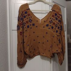 Gorgeous Free People Too, Goldish Mustard With Blue/ Purple Stitched Designs. V-Neck Front And Back. Brand New, One Size. Fitted V-neck Brown Blouse, Beige V-neck Top For Festival, V-neck Festival Tops For Fall, Beige V-neck Tops For Festivals, Fitted Brown V-neck Blouse, Brown Bohemian V-neck Top, Chic Brown Festival Tops, Chic Brown Tops For Festival, Off Shoulder Floral Top