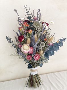 a vase filled with lots of different types of flowers