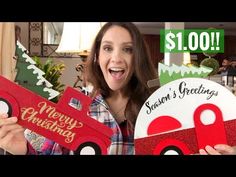 a woman holding two christmas gifts in front of her face with the words santa's greetings written on them