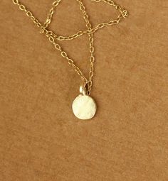 Tiny gold dot necklace - everyday necklace - dainty necklace - dot necklace - circle necklace - a tiny gold disc on a 14k gold vermeil chain This dainty and delicate 22k gold vermeil dot hangs from a 16 inch 14k gold vermeil chain.. Please feel free to select a different length if you prefer! Need an energy boost? Or a little pop of color? https://www.etsy.com/listing/165088081/add-a-gemstone-power-boost-healing-gem?ref=shop_home_active The Hand (Khamsa), particularly the open right hand, is a s Dot Necklace, Necklace Everyday, Gold Dot, Gold Disc, Energy Boost, Everyday Necklace, Gold Dots, Circle Necklace, Necklace Dainty