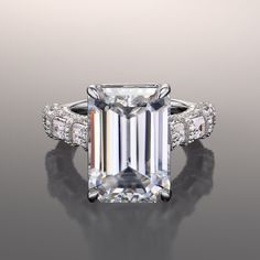 an emerald - cut diamond ring with side stones