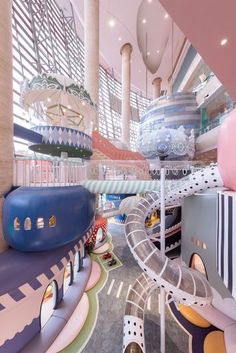 an indoor play area with slides and toys