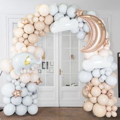 an elephant balloon arch with stars and moon balloons on the top, along with other balloons