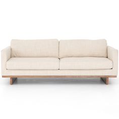 a white couch sitting on top of a wooden frame